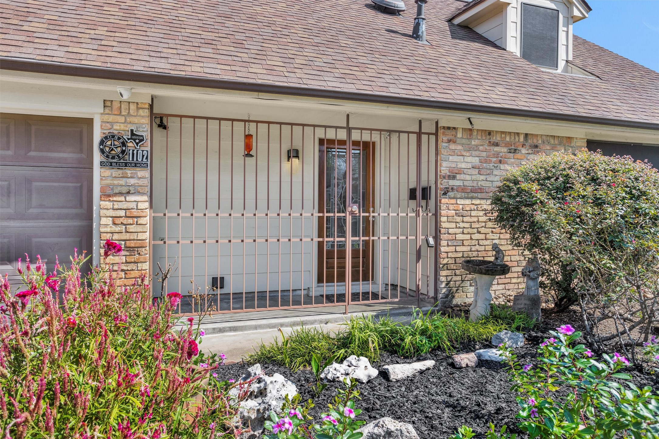 1102 Mosher Lane Houston, TX 77088 - Photo 2 of 50 a front view of a house with a garden