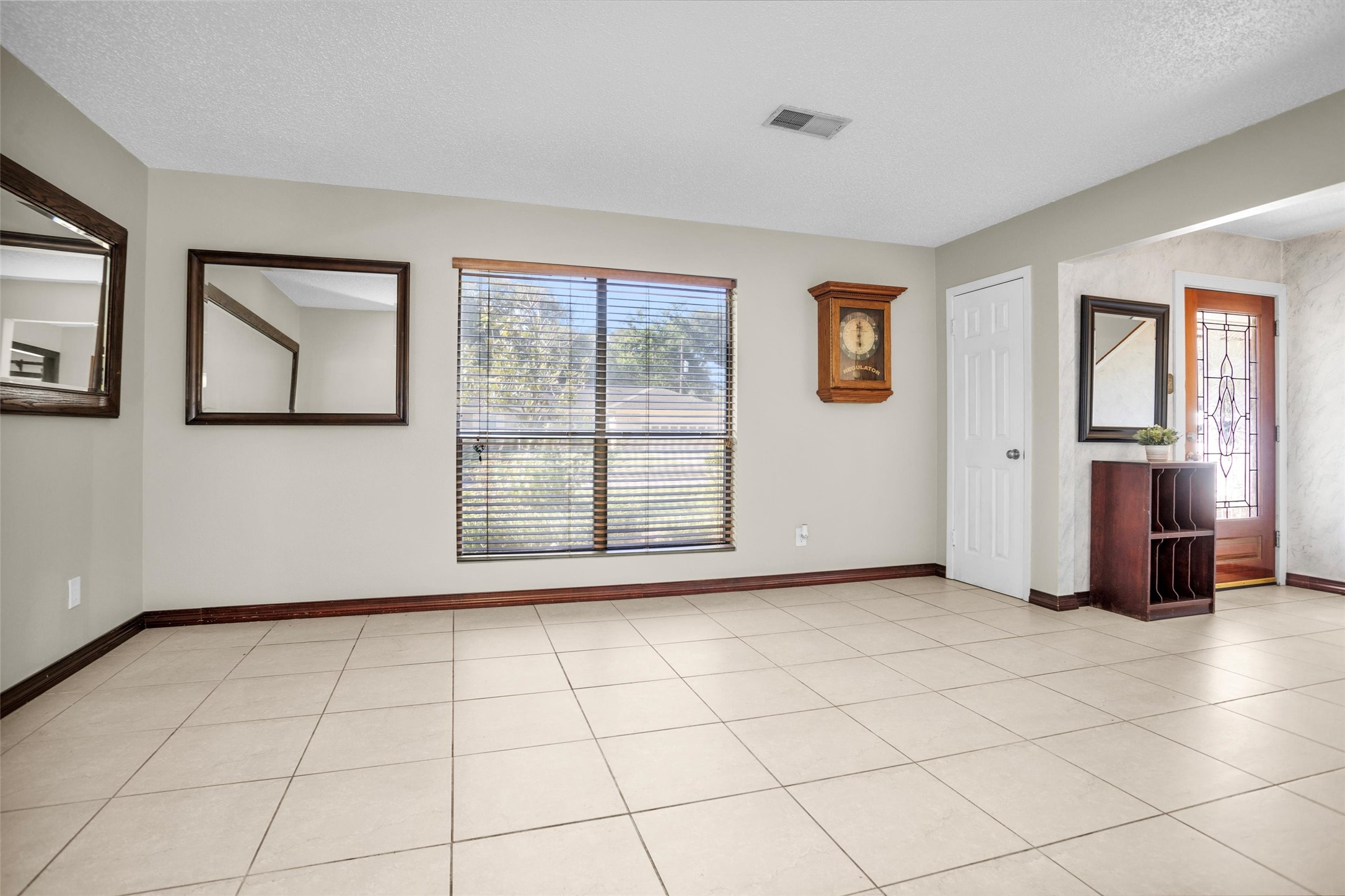 1102 Mosher Lane Houston, TX 77088 - Photo 7 of 50 a view of an empty room with window and wooden floor
