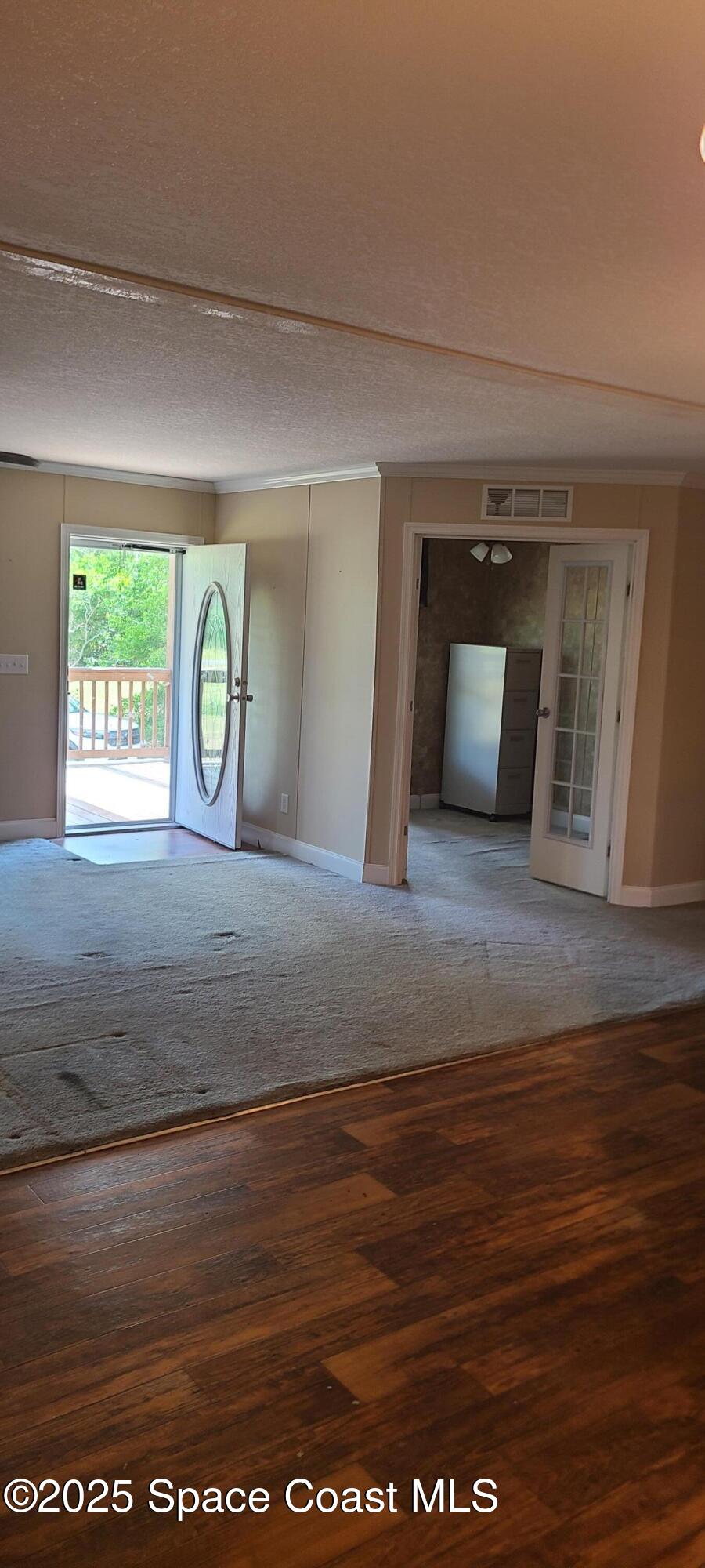 17189 County Road 252 Live Oak, FL 32060 - Photo 7 of 31 a view of empty room with window and hardwood floor
