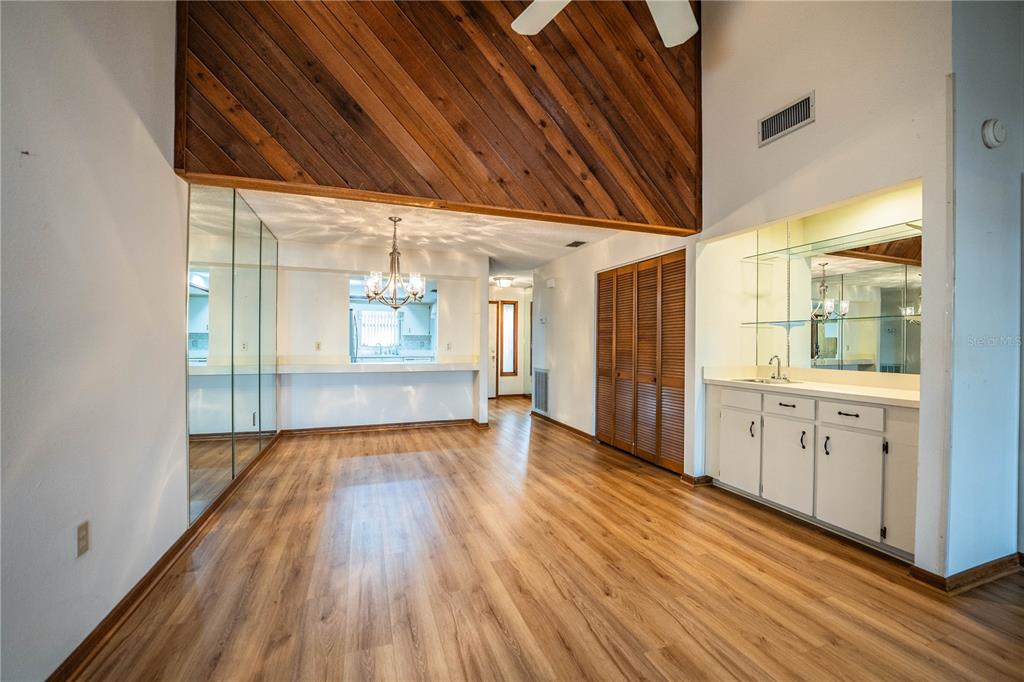 2025 Sylvester Road, Unit AA1 Lakeland, FL 33803 - Photo 13 of 65 a view of an empty room with wooden floor and a window