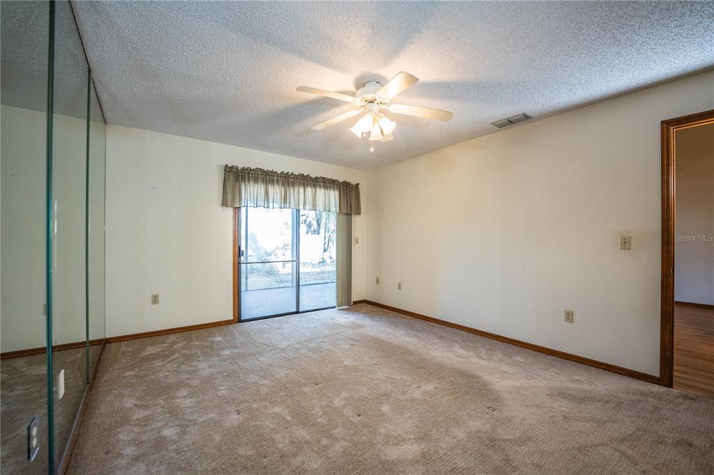 2025 Sylvester Road, Unit AA1 Lakeland, FL 33803 - Photo 27 of 65 an empty room with windows and fan
