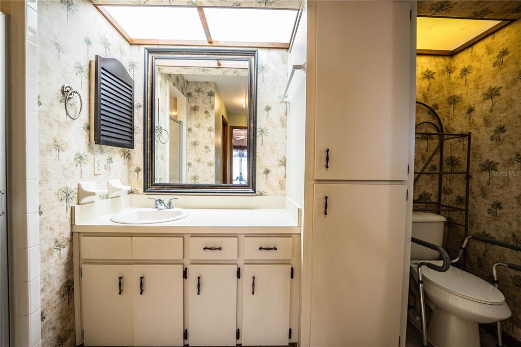 2025 Sylvester Road, Unit AA1 Lakeland, FL 33803 - Photo 33 of 65 a bathroom with a sink and a mirror