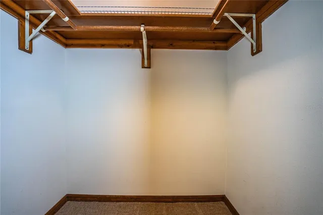 a view of a livingroom with a ceiling fan and window