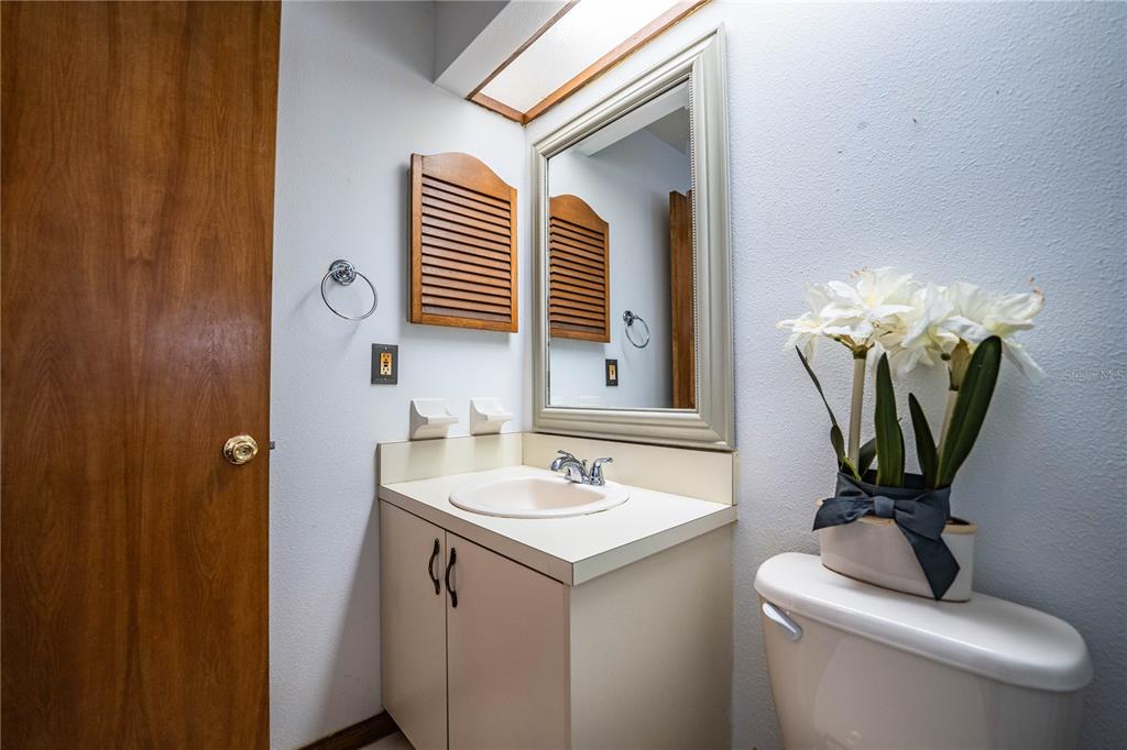 2025 Sylvester Road, Unit AA1 Lakeland, FL 33803 - Photo 40 of 65 a bathroom with a toilet sink and mirror