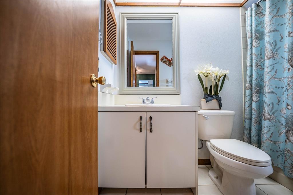 2025 Sylvester Road, Unit AA1 Lakeland, FL 33803 - Photo 42 of 65 a bathroom with a toilet a sink and mirror