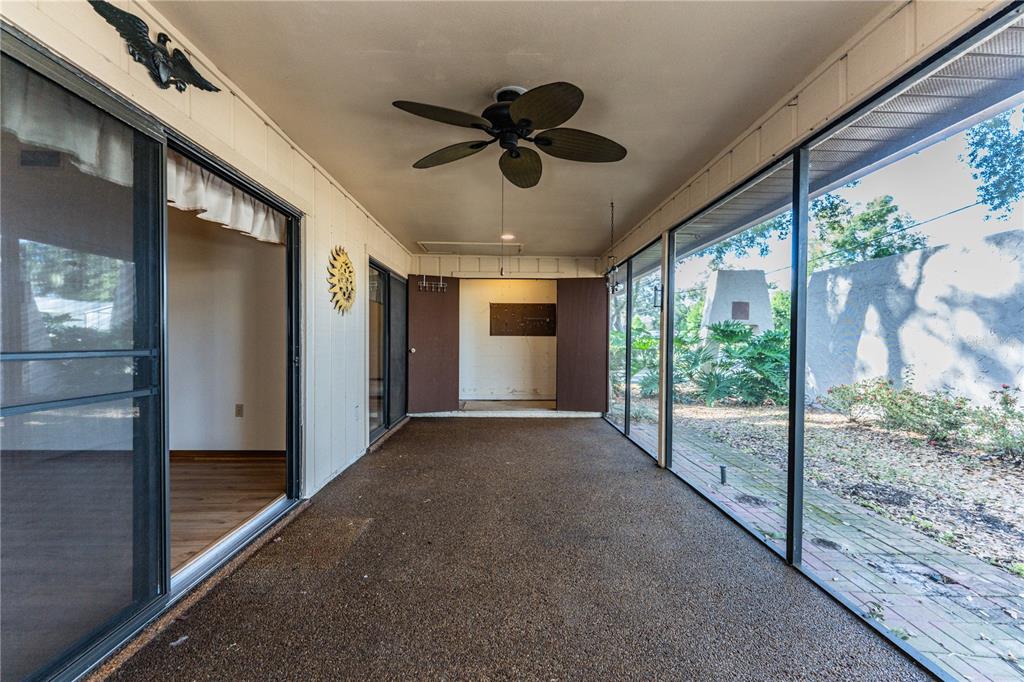 2025 Sylvester Road, Unit AA1 Lakeland, FL 33803 - Photo 46 of 65 a view of a livingroom with a ceiling fan and window