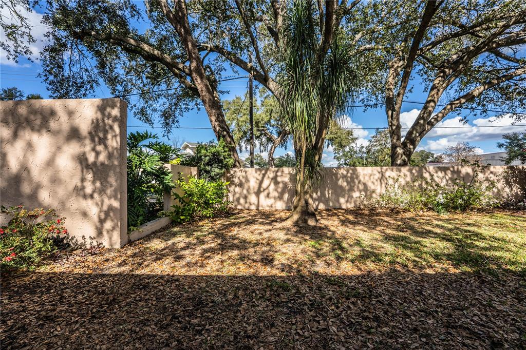 2025 Sylvester Road, Unit AA1 Lakeland, FL 33803 - Photo 48 of 65 a view of a yard with plants and trees
