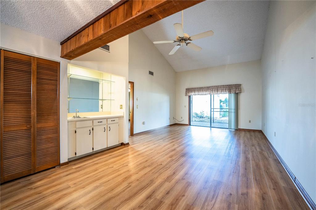 2025 Sylvester Road, Unit AA1 Lakeland, FL 33803 - Photo 5 of 65 a view of an empty room with window and wooden floor