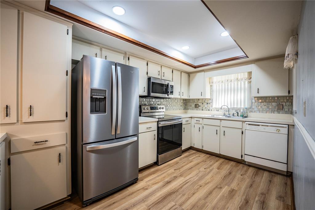 2025 Sylvester Road, Unit AA1 Lakeland, FL 33803 - Photo 7 of 65 a kitchen with a refrigerator stove and sink