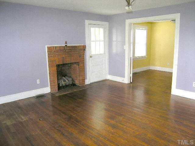 Living room with gas log fireplace, side entrance and French doors into the dining room Living Room