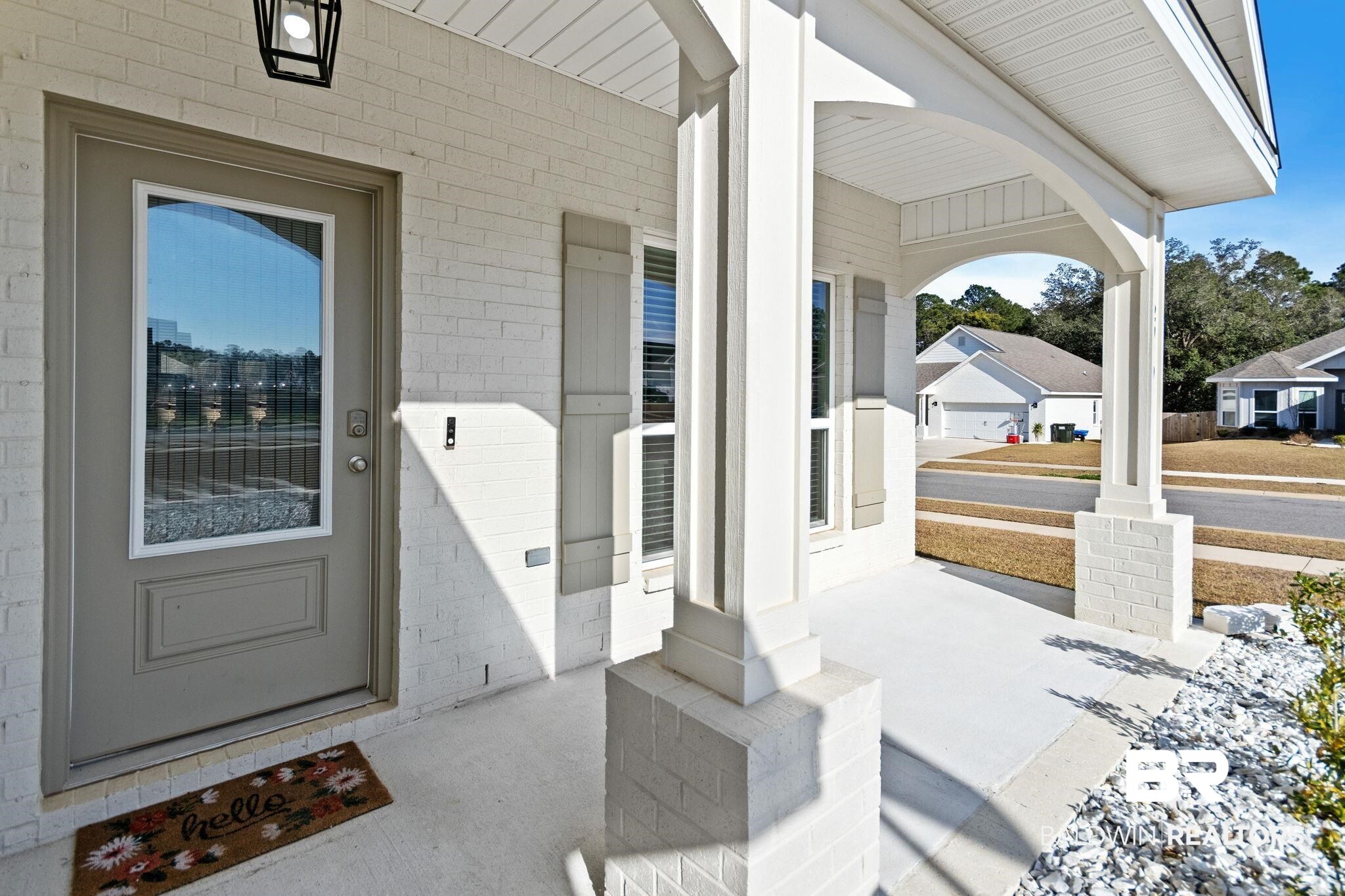 12919 Torrent Road Fairhope, AL 36532 - Photo 14 of 74 View of exterior entry with a porch and concrete block siding