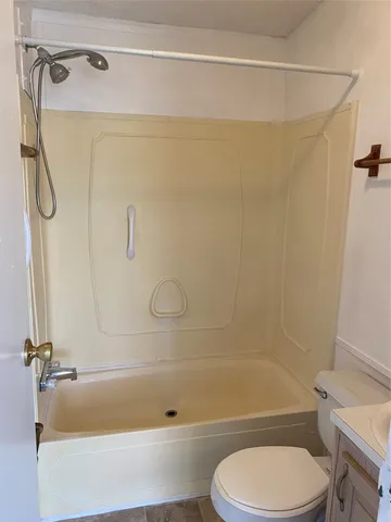 a bathroom with a toilet and a shower