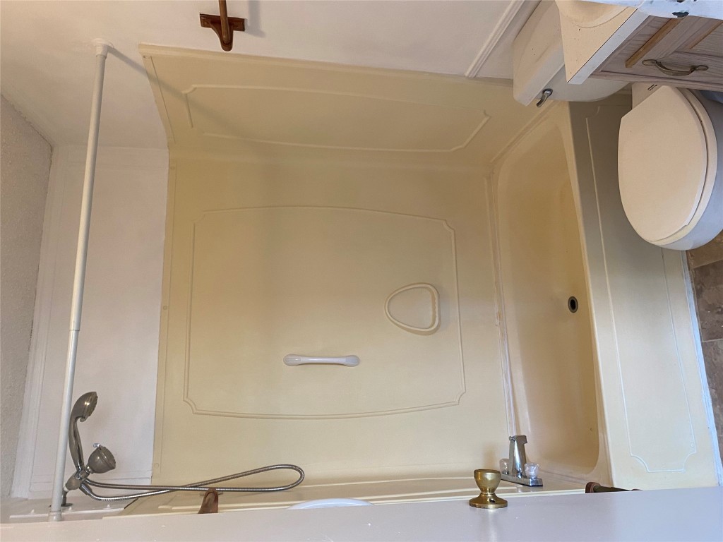 125 Kellar Road, Unit 1 Smithville, TX 78957 - Photo 16 of 18 a bathroom with a toilet and a shower