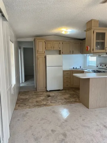 a view of a kitchen with a sink and cabinets