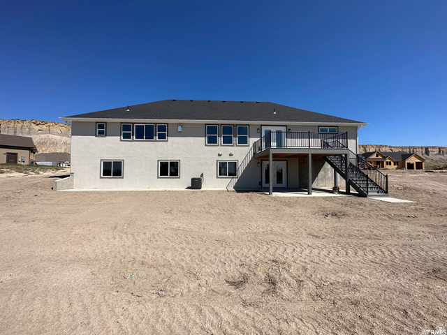 1171 West 2330 North Helper, UT 84526 - Photo 25 of 26 Rear view of property featuring a patio area, a wooden deck, and stucco siding