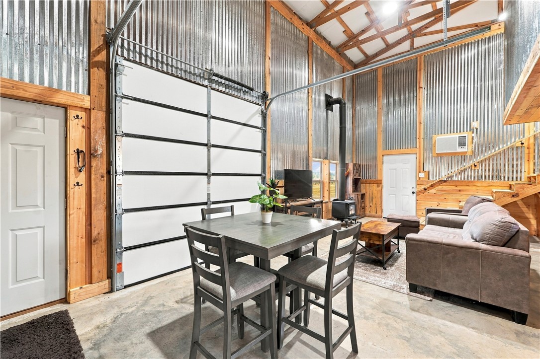 8800 Fred Austin Road Decatur, AR 72722 - Photo 52 of 60 Living area in barn apartment with wood stove for heat and AC on the walls.