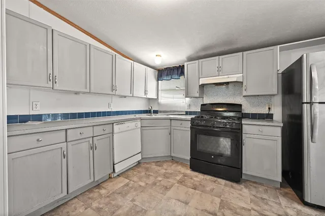 a kitchen with stainless steel appliances granite countertop a refrigerator sink and cabinets