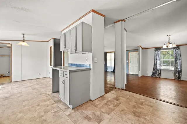 a view of a kitchen with refrigerator and wooden floor