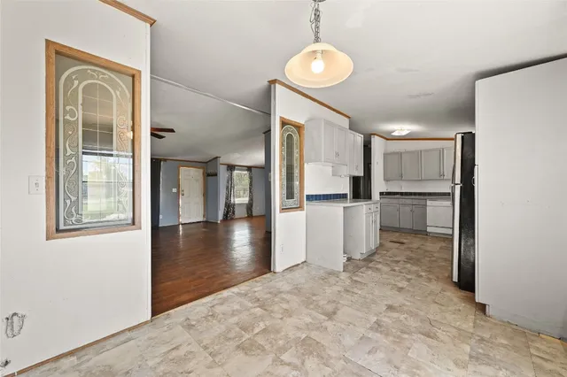 a view of a kitchen with a refrigerator and microwave