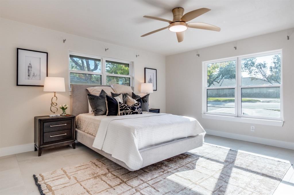 7115 Meadow Road Dallas, TX 75230 - Photo 13 of 22 This property features a spacious room with light-colored walls and flooring, complemented by a ceiling fan with integrated lighting