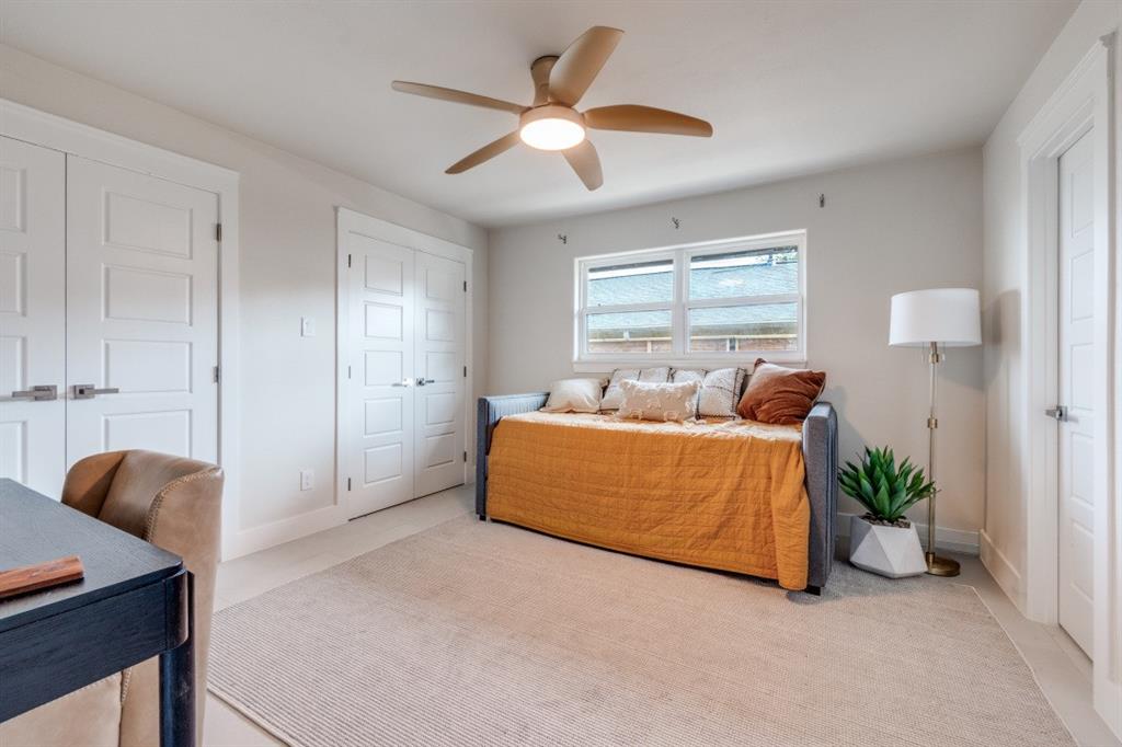 7115 Meadow Road Dallas, TX 75230 - Photo 16 of 22 This room features light-colored walls and flooring, with a ceiling fan providing air circulation