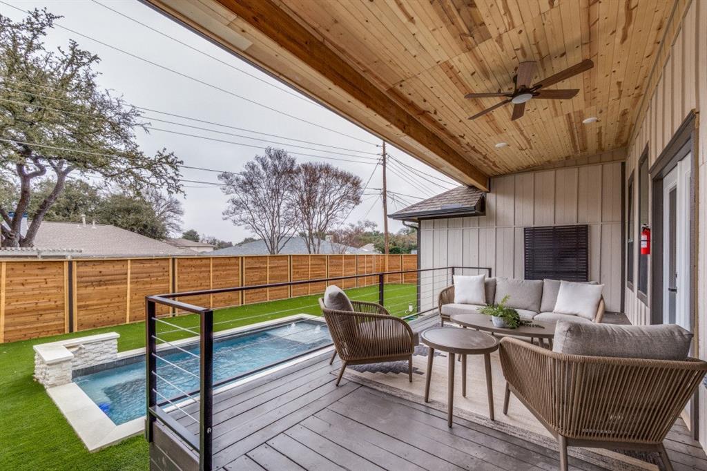 7115 Meadow Road Dallas, TX 75230 - Photo 20 of 22 The property features a spacious covered patio with a wooden plank ceiling and a ceiling fan