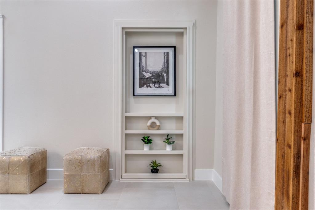 7115 Meadow Road Dallas, TX 75230 - Photo 8 of 22 Built-in shelving unit with decorative elements