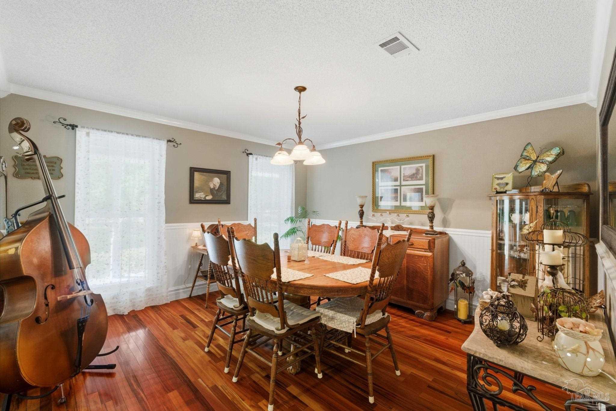 6930 Summit Way Milton, FL 32570 - Photo 13 of 71 a living room with furniture a chandelier and a dining table