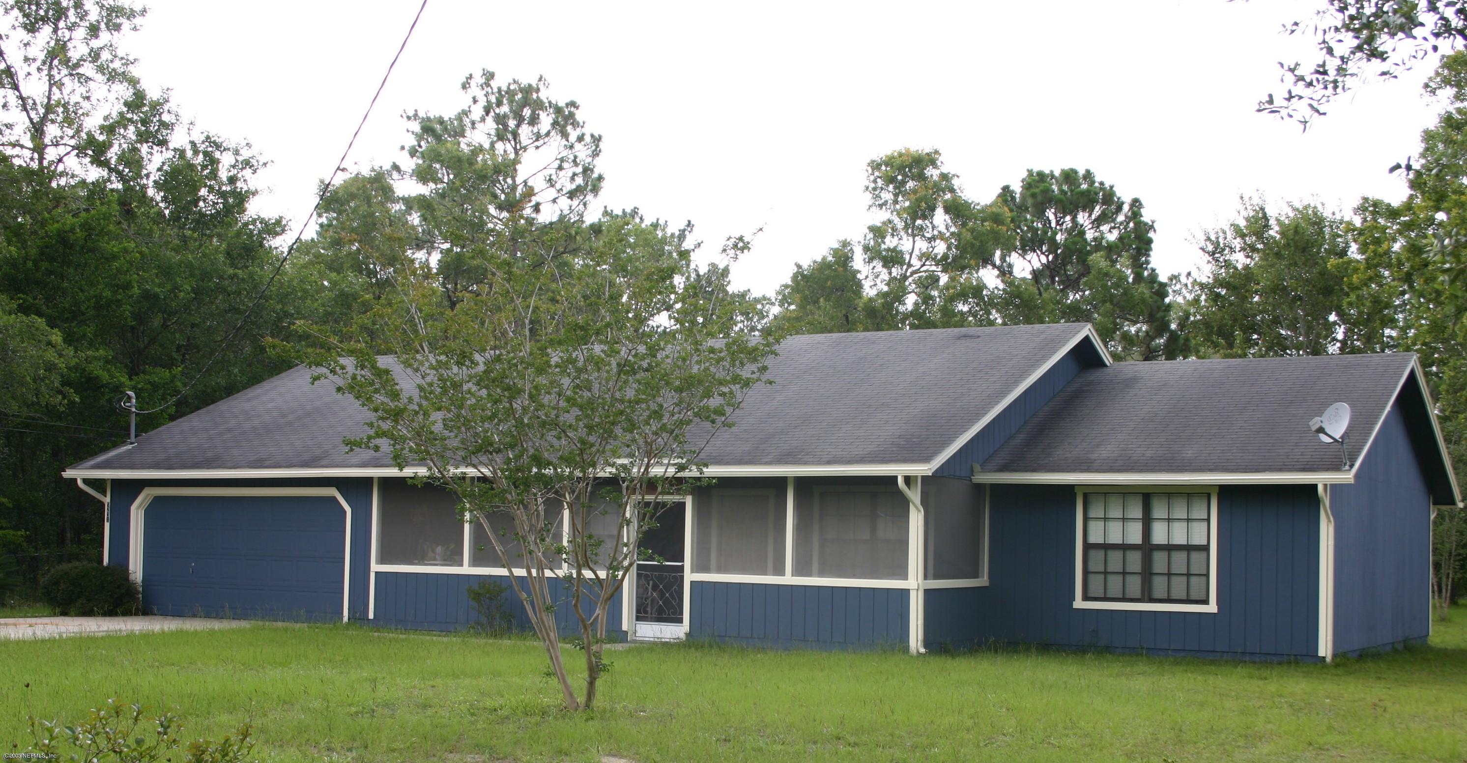 9231 Hipps Road Jacksonville, FL 32222 - Photo 1 of 6 a front view of a house with a garden
