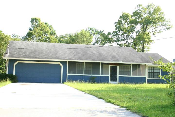 9231 Hipps Road Jacksonville, FL 32222 - Photo 6 of 6 a house view with a garden space