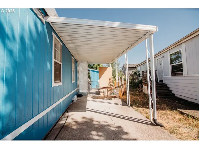 a view of a patio with table and chairs