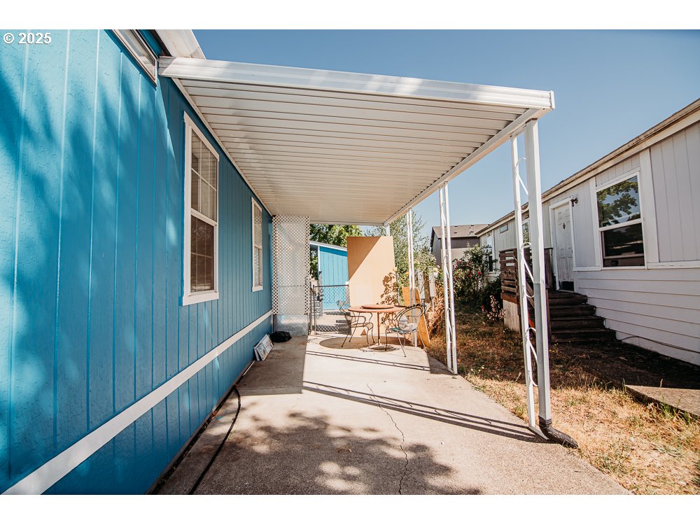 a view of a patio with table and chairs