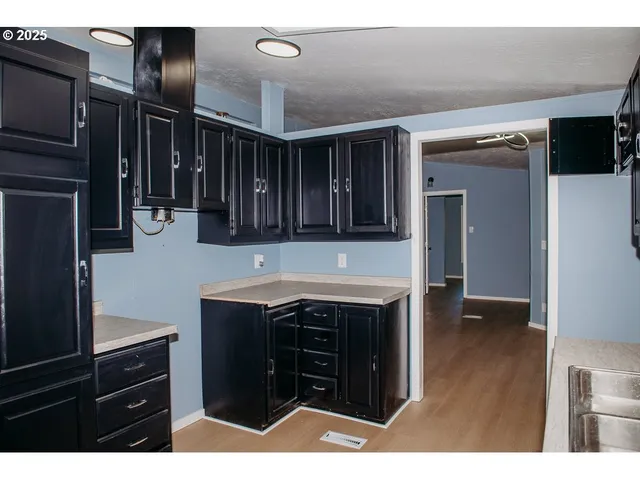 a kitchen with a sink and cabinets