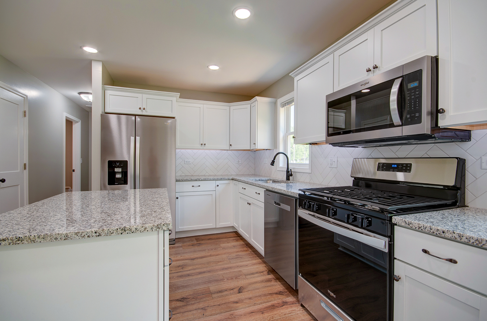 386 West 3rd Street Braidwood, IL 60408 - Photo 14 of 36 a kitchen with stainless steel appliances granite countertop a stove a refrigerator and a microwave