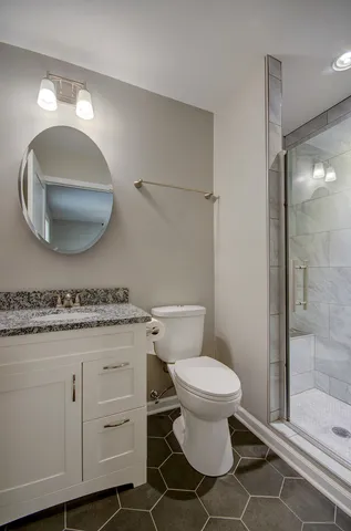 a bathroom with a toilet a sink and mirror