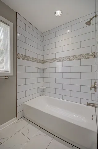 a bathroom with a bathtub and shower