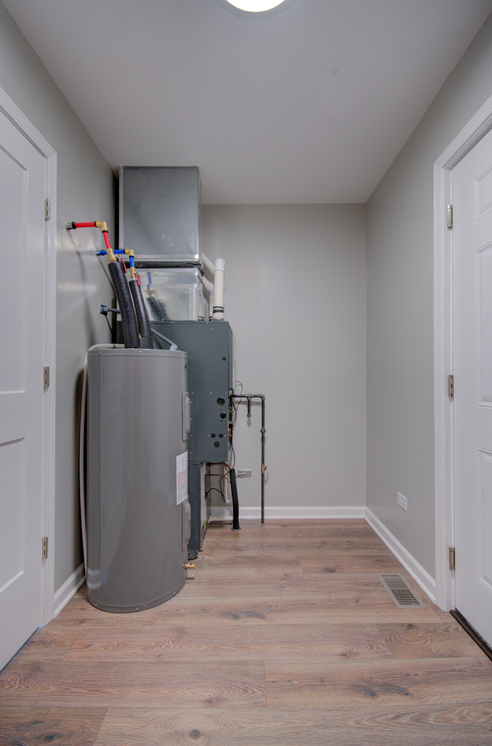 386 West 3rd Street Braidwood, IL 60408 - Photo 29 of 36 a view of storage and utility room with wooden floor