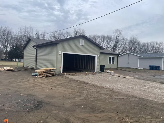 a view of a house with a yard and garage