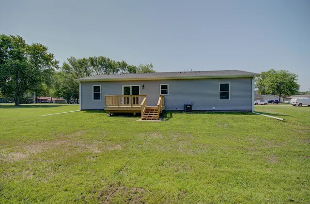 a view of a house with a yard and sitting area