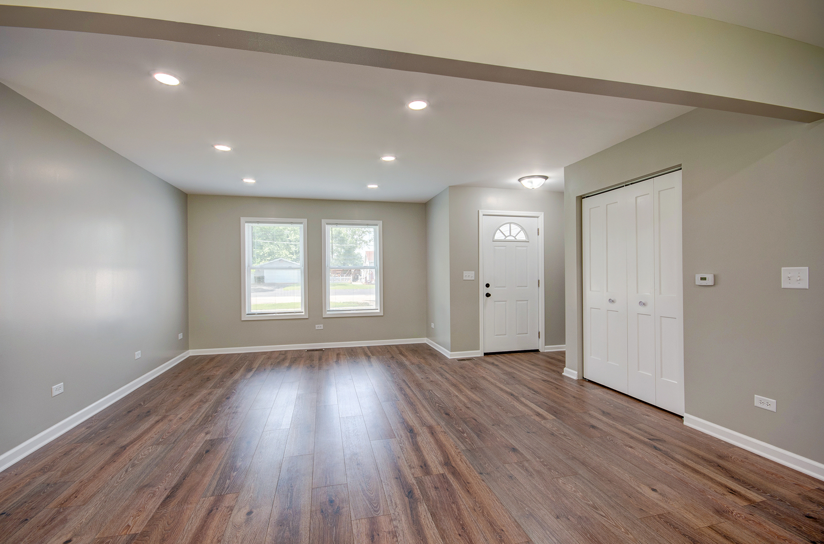 386 West 3rd Street Braidwood, IL 60408 - Photo 9 of 36 an empty room with wooden floor and windows