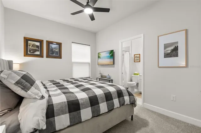 a bedroom with a bed and painting on the wall