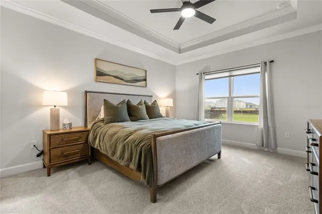 a spacious bedroom with a bed and a window