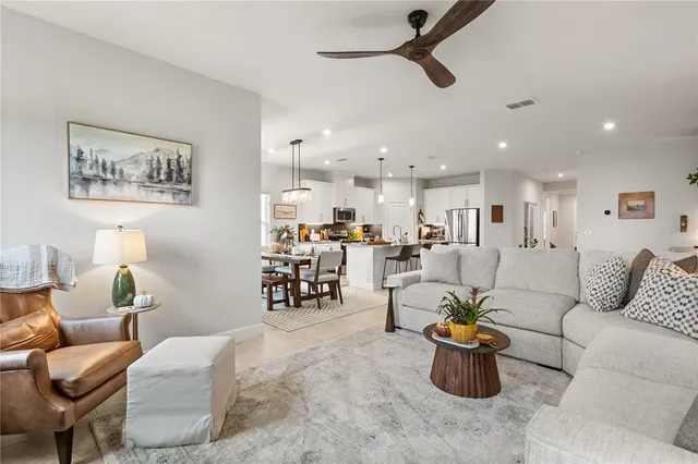 a living room with furniture and kitchen view