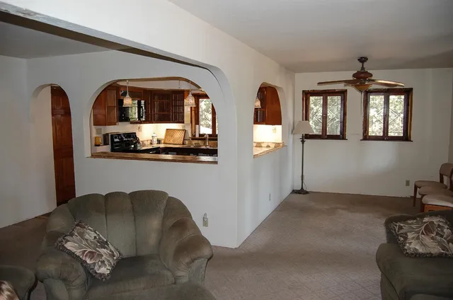 a living room with furniture and a wooden floor