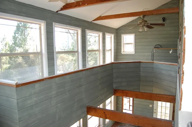 a living room with a bed and a window