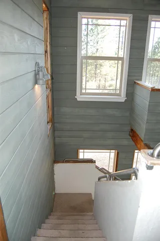 a view of an empty room with cabinet and windows