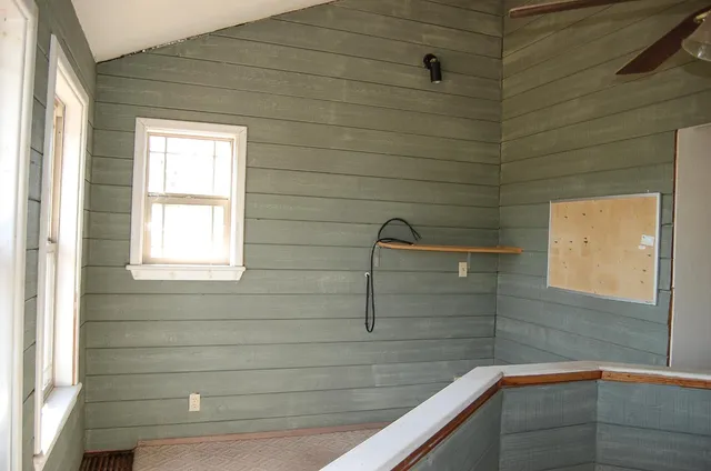 a view of a room with a window and wooden floor