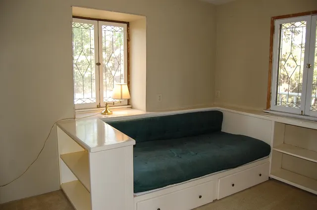 a front view of house with yard and trees around