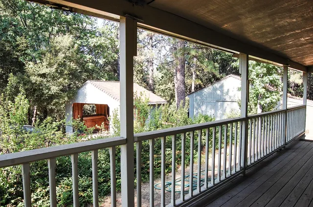 a view of a balcony with wooden floor