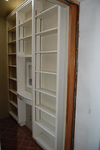 a view of walk in closet with empty racks